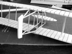 16. Turn the glider right side up and glue the bottom two rudder braces to either side of the opening in the lower wing.