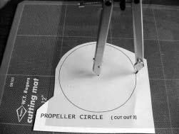 Draw pieces of smaller circles on the plastic circle with the black marker. Make a small hole in the very center of each circle with a toothpick.