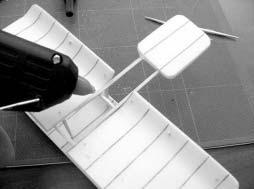 7. Now, with both the upper and lower wings and wings upside down (the edges should be curving up at this point), insert the back row of spars into the