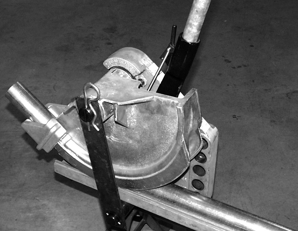 E. Removing Conduit 1. After a bend is complete, pull the release lever back. 2. Move the ratchet handle up until the pawls click together and release the shoe teeth, figure 13. 3.