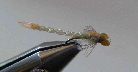 Twisted Damsel Fly He uses liquid lace but he does not put oil in it for this fly. Twist the lace. Pull it to get rid of loop. Then leave the loop.