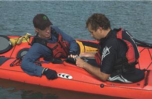 rescuers kayak to maintain a solid raft.