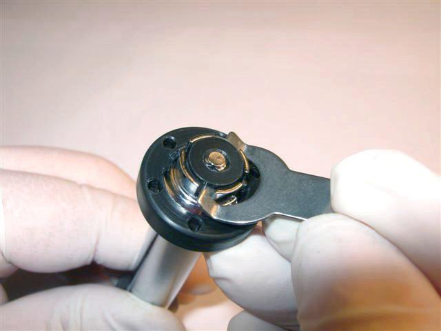 Remove Nylock nut (27) using 7mm nut driver or