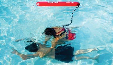 If an assisting lifeguard is there with the backboard, skip this step and proceed to remove the victim from the water.