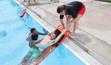 The rescuing lifeguard raises one of the victim s arms so that the assisting responder can grasp the arm.