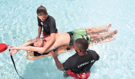 The assisting responder(s) on deck brings the backboard to the edge of the water and removes the head immobilizer, placing it within reaching distance.