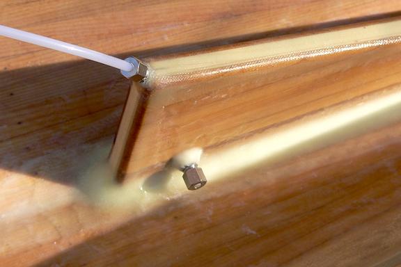 Next, the boat was turned over and, using a strip of sandpaper wrapped around the right width of wood, I slowly widened the slot until the hull opening exactly matched the inside walls of