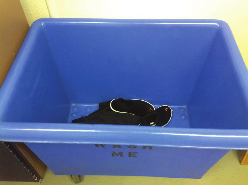 18 Back in the locker room, I will take off my wetsuit, turn it right side out, and put it in a bin that says Wash Me.