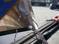 Put the rest of the halyard in the zipper and then close the zipper completely. Step 5 Step 6. Take the jib cunningham and tie it down to the ring in the tack of the jib.