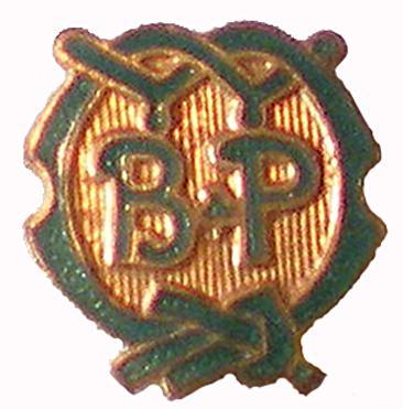 Guide Guider Appointment Pin 1. A1070 3. 1910-191? 4. Irregular; metal; brass: text BP in centre with Ribbon of Courage as border in green enamel, W (Warrant) at top. 1. A1071 3. 191?-1918 4.