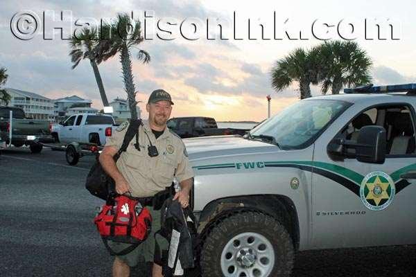 FWC Officer Robert Johnston is seen as the sun rises in the