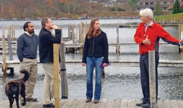 Dr. Sudeep Chandra, Ted Thayer, Meg Modley, and Peter Bauer discuss benthic barrier matting challenges and successes at the Norowal treatment site in Lake George, NY Photo courtesy of Lake George