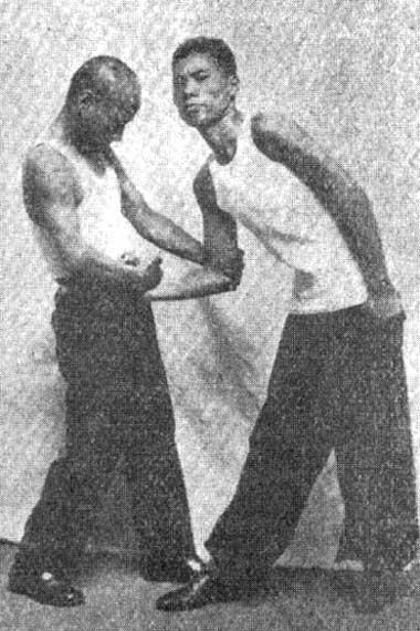 Paragraph 3 DING WAN: Propping a wrist. This method is used if the enemy seized you by the waist belt or clothes in the region of the stomach from the front.