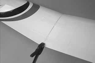 Slide the pre-installed vertical fin bolts through the holes in the horizontal stabilizer. 2.