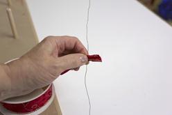 Slip the wire between pinch and finger.