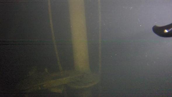 close to the decking. Figure 45 is an image of the forward periscope, with the "training ring" and control unit near the bottom of the image and showing that the lifting wires are slack.
