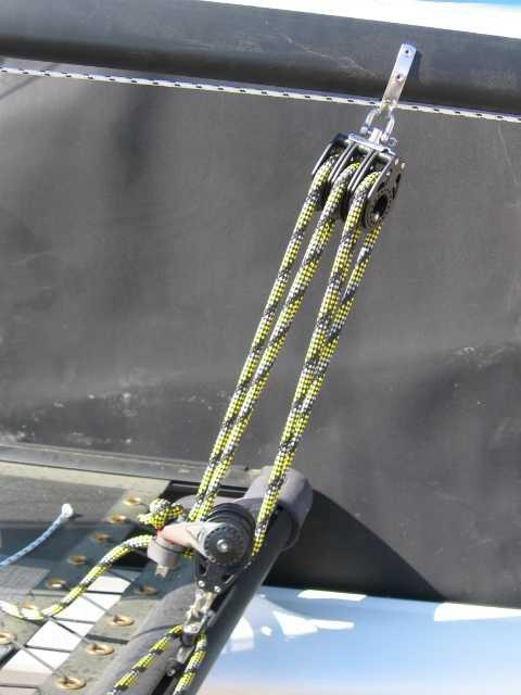 Tie a eight figure knot at the end of the mainsheet and feed it through the upper strap of the ratchet block and then, up into the first sheave of the boom block from front to rear down into the