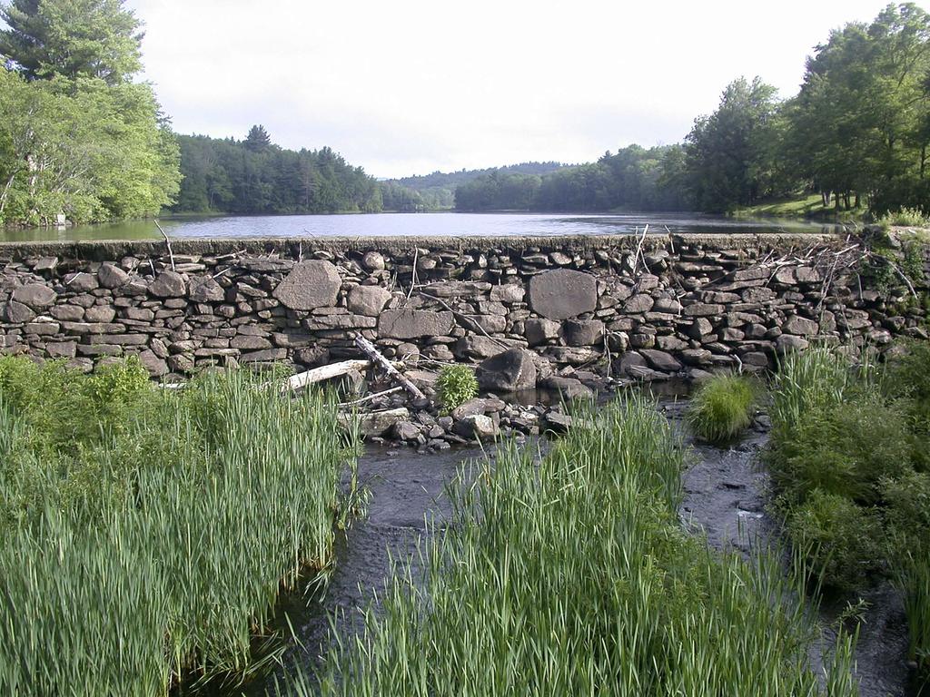 The old stone dam at the outlet of Hayden Pond in Otis, Massachusetts, is a decrepit structure that may fail.