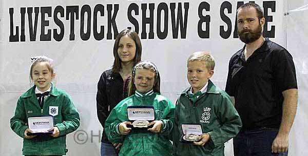Holding buckles for winning in Showmanship of Fat Steer in the Primary Division are (from left) First Place - Ryleigh