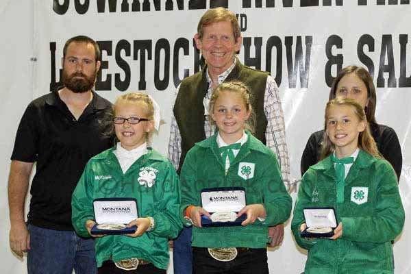 Winners of Showmanship in Feeder Steer in the Primary Division stand with sponsor Dr. Bill Martin (back row, center) of Martin Orthodontics.