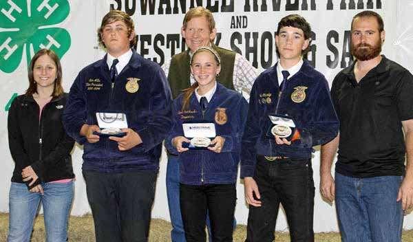 Wranglers 4H. Winners of Showmanship in Feeder Steer in the Junior Division stand with sponsor Dr. Bill Martin (back row, center) of Martin Orthodontics.