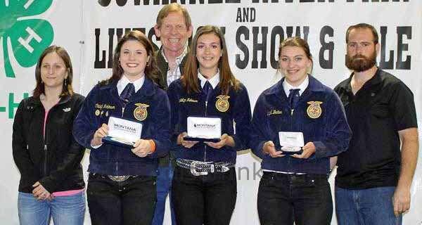 Winners of Showmanship in Feeder Steer in the Senior Division stand with sponsor Dr.