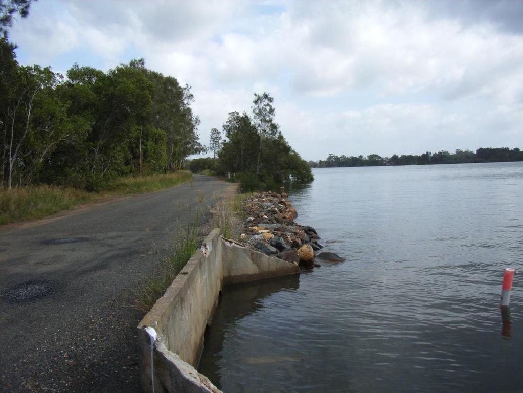 Figure 9: Rock lined river bank area along Fernbank Creek Road The width of fringing mangrove vegetation adjacent to Fernbank Creek Road increases to 30m further downstream where the road passes