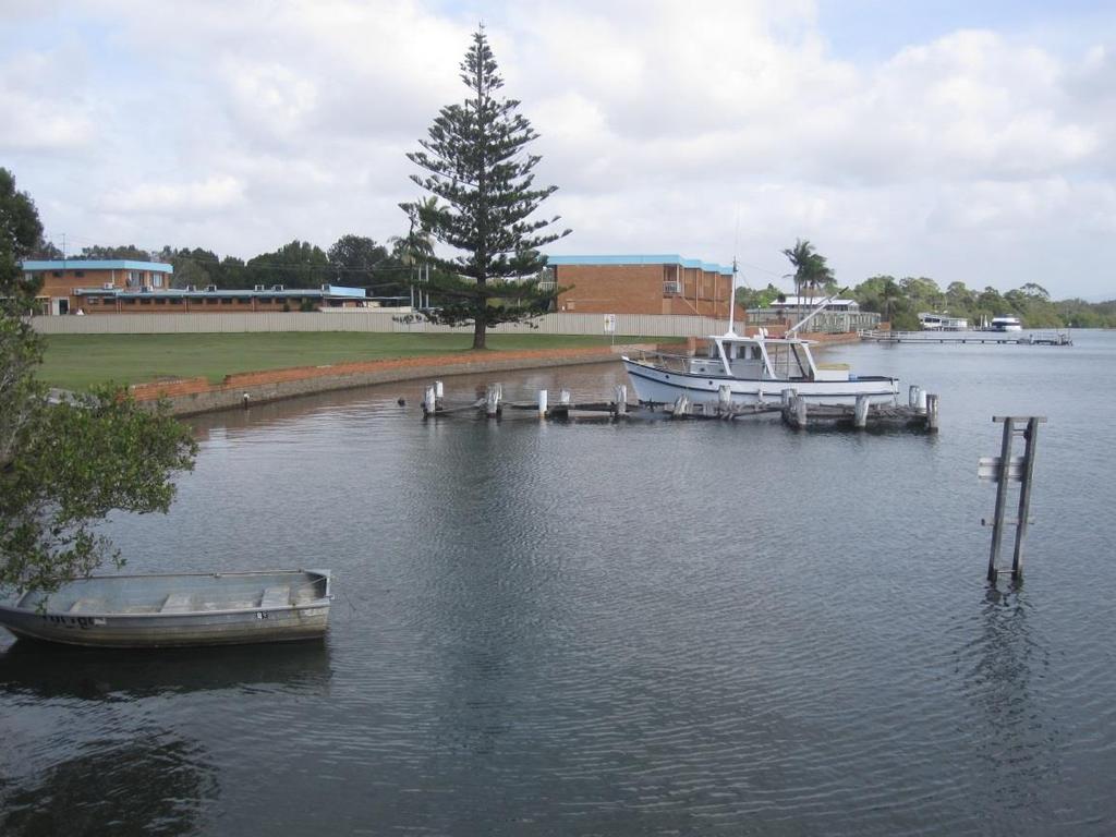 Figure 10: Blockwork retaining wall along foreshore extending from Aquatic Caravan Park The shoreline in the vicinity of the ferry ramp consists of a low-level bank with little to no riparian