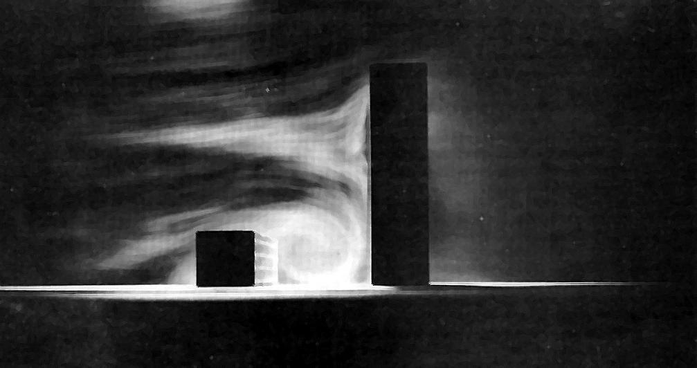 Figure 3: Illustration of a rolling vortex formed by wind flowing over low rise building into a taller building. Image Source: Blocken B, Carmeliet J.