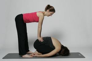 Child s Pose Stand behind your student, and squat down so you can reach their back Place your hands on each side of their spine, near the sacrum area, with your fingers facing out Keeping your arms
