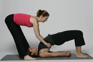 Bridge Stand with your feet on either side of your student s arms facing towards their feet.