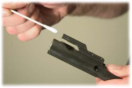 Clean carbon and powder residue from vent holes and outer and inner surfaces of the bolt carrier.