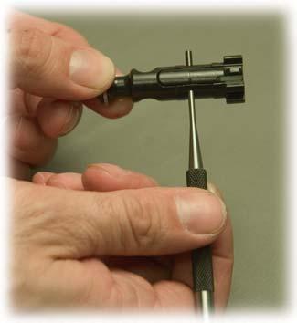 50 Fig. 51 14. Remove extractor pin by pushing it out with the p of the firing pin or a punch.
