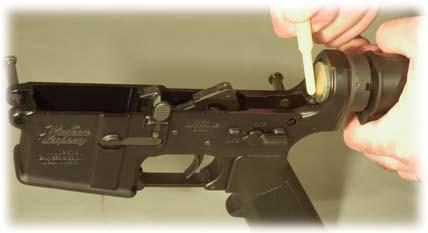 INSTALL THE CHARGING HANDLE: Insert the charging handle into the upper receiver and align the tabs on the charging handle with the corresponding