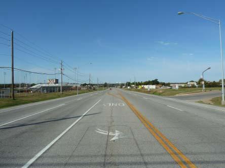 S South East Ave is a rural 2-lane street that serves as the entry drive to the Coweta High School.