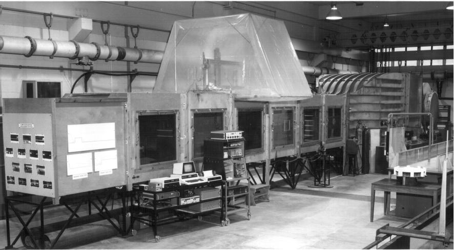 ) Wind tunnels may be open return, as shown in the photo above, where the air ejects into the laboratory (upwards at the near end in this case) or closed loop, where the air continually