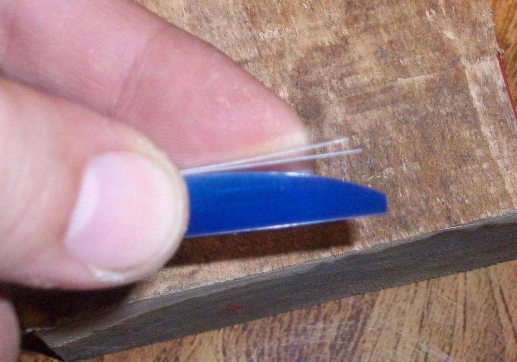 reeds up evenly with each other. Then push the wedge into the cork notch to hold the reeds in place, as shown below.