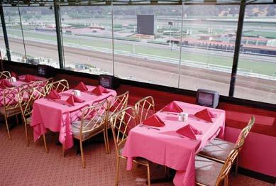This glassed-in, climate-controlled dining room offers gourmet fare, complimentary race-day programs, and is conveniently located near private wagering