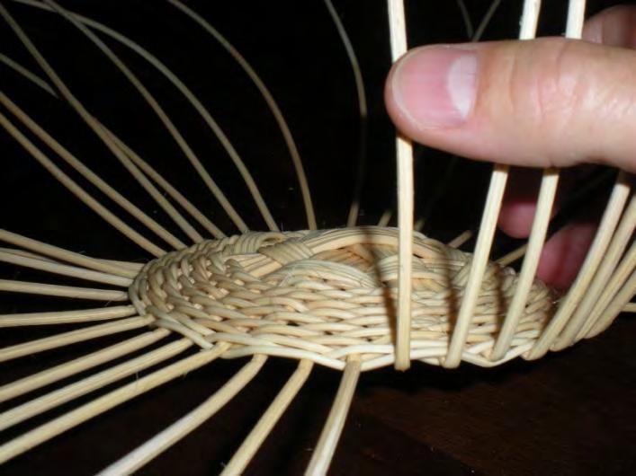Upsetting the spokes: Soak the base for several minutes, then pinch each spoke where it emerges from the base weaving, then carefully bend them up towards the higher domes