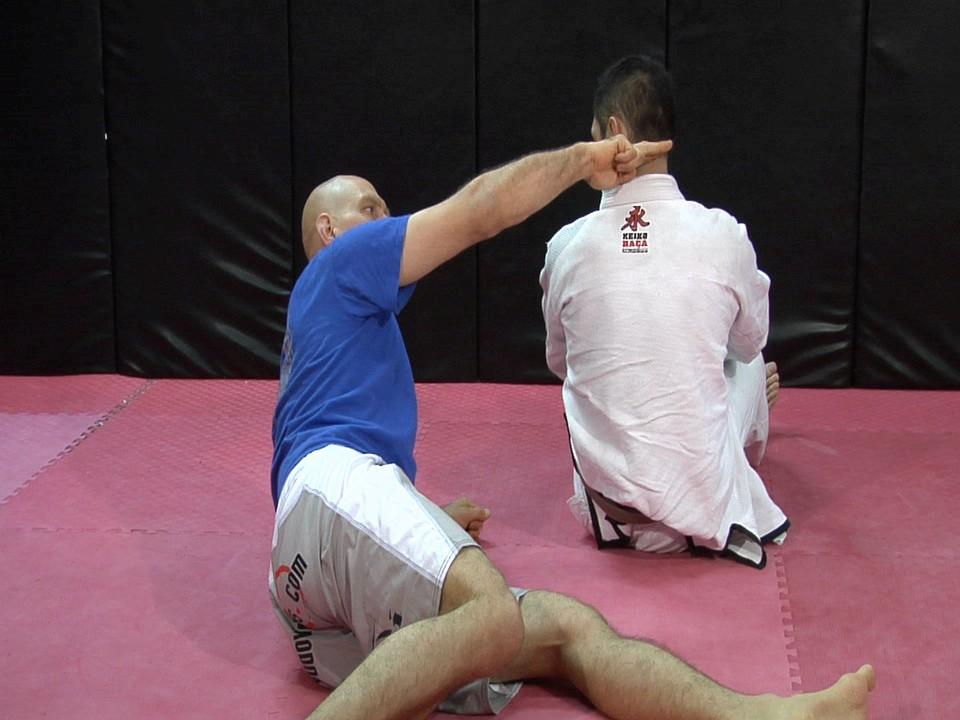 Detail 3: leg positioning in yoko sankaku jime. For this choke to work your bottom leg must be across the back of your opponent's neck - sort of like a chopping block.