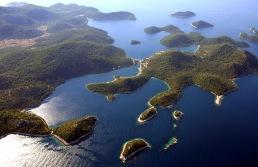 ..green island in the midst of the blue Adriatic open sea, surrounded by numerous small silver islands.