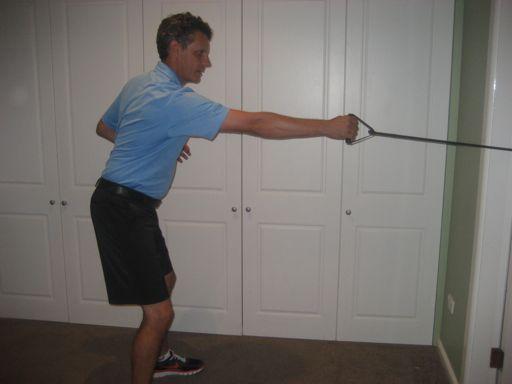 5. Standing Cable/Resistance Band Pull The golfer stands holding the handles