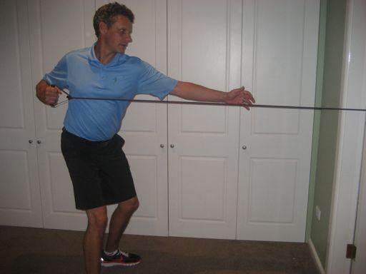 Maintaining their posture at all times, the golfer pulls the handles