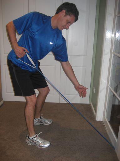 Maintaining golf posture, the golfer pulls the handle straight back,