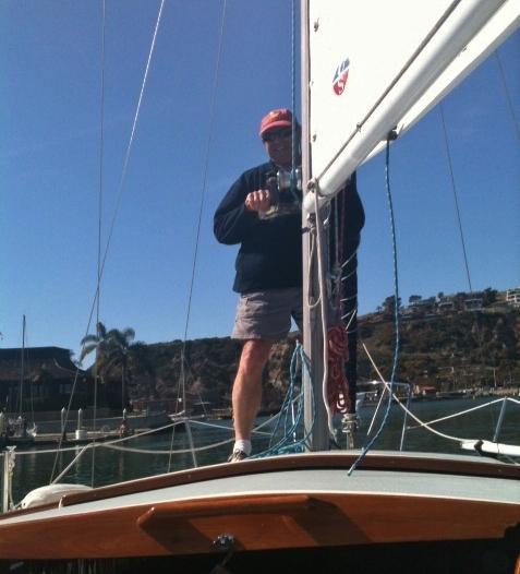 Peter Teitz hoisting the mainsail We pass alongside the jetty we see many perched sea birds.