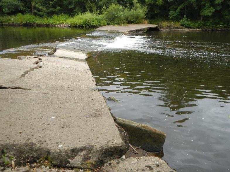 The upper of the two weirs at the downstream limit, which impounds
