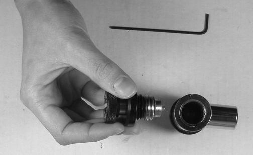 Loosen the small set screw located on the chrome body of the Pop-off Valve.