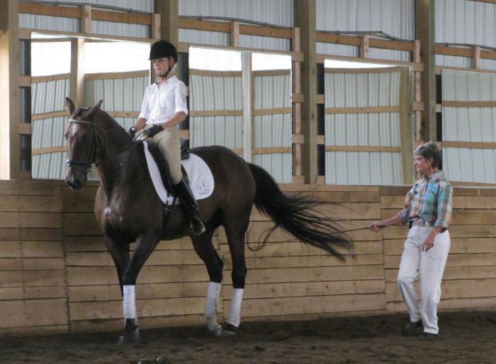 First Level demo rider Nina Catazanrite and Rumba uses her activating aids to get her horse to step more under. horse s belly or abdominal muscles that support its back.