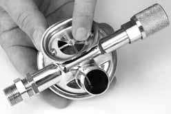 9) Place the castle wrench in the inlet nipple side of the demand regulator over the soft seat of the inlet valve to prevent the inlet valve from rotating. 7.
