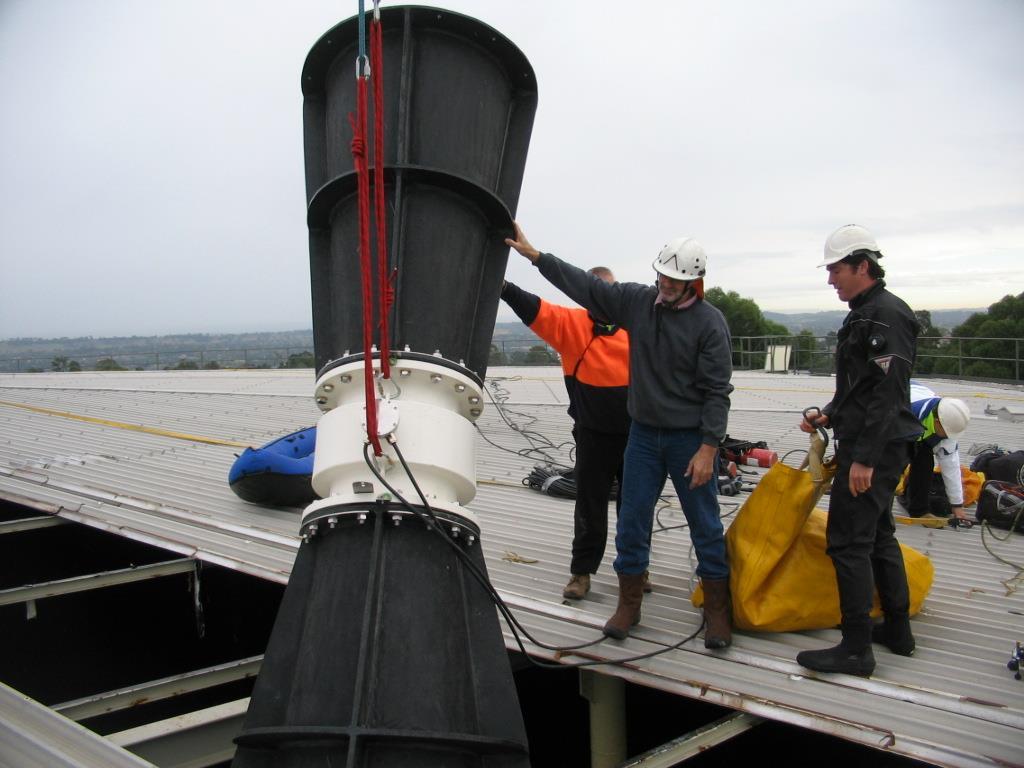 Figure 3: A partially completed flowmeter unit being lowered though the roof of a reservoir. The diver prepares to connect a lift bag to assist in positioning the unit underwater.